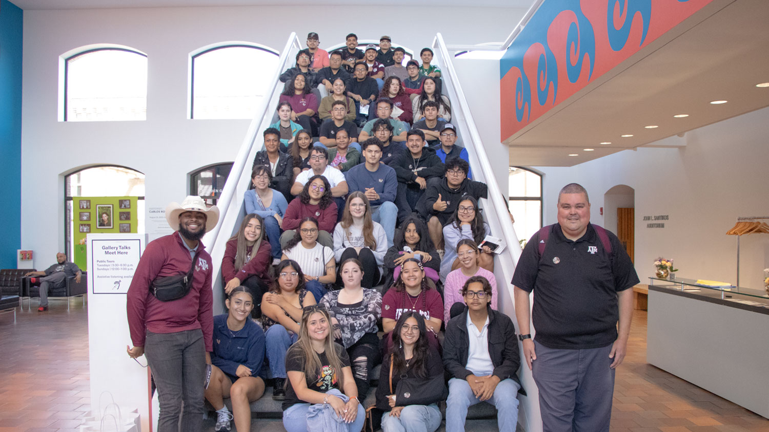 Explorations group photo with 40 students sitting on a stairwell.