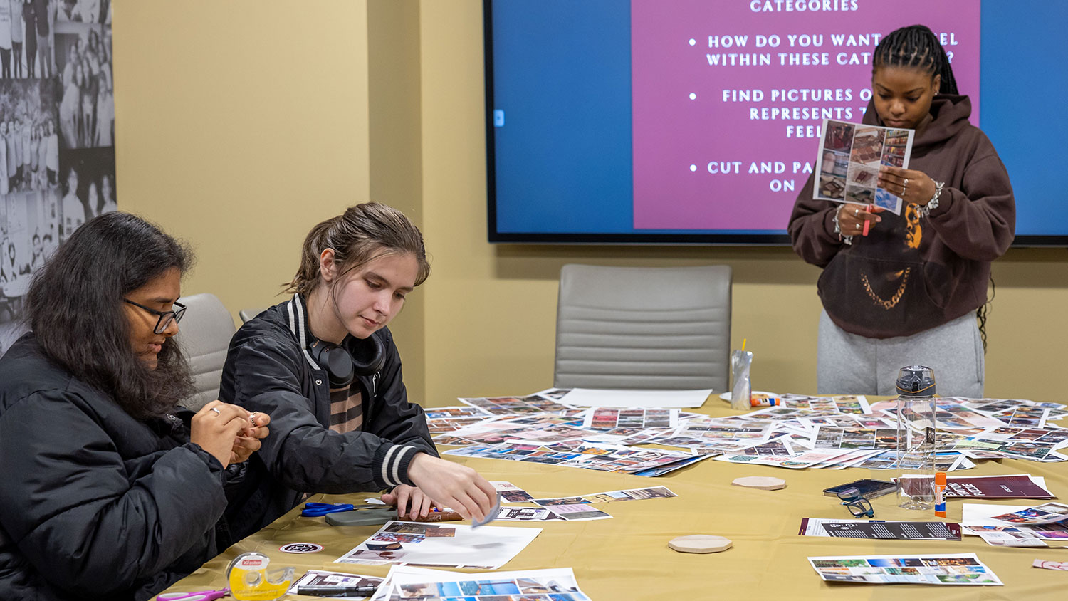 Group of students making mood boards at a DMS event.